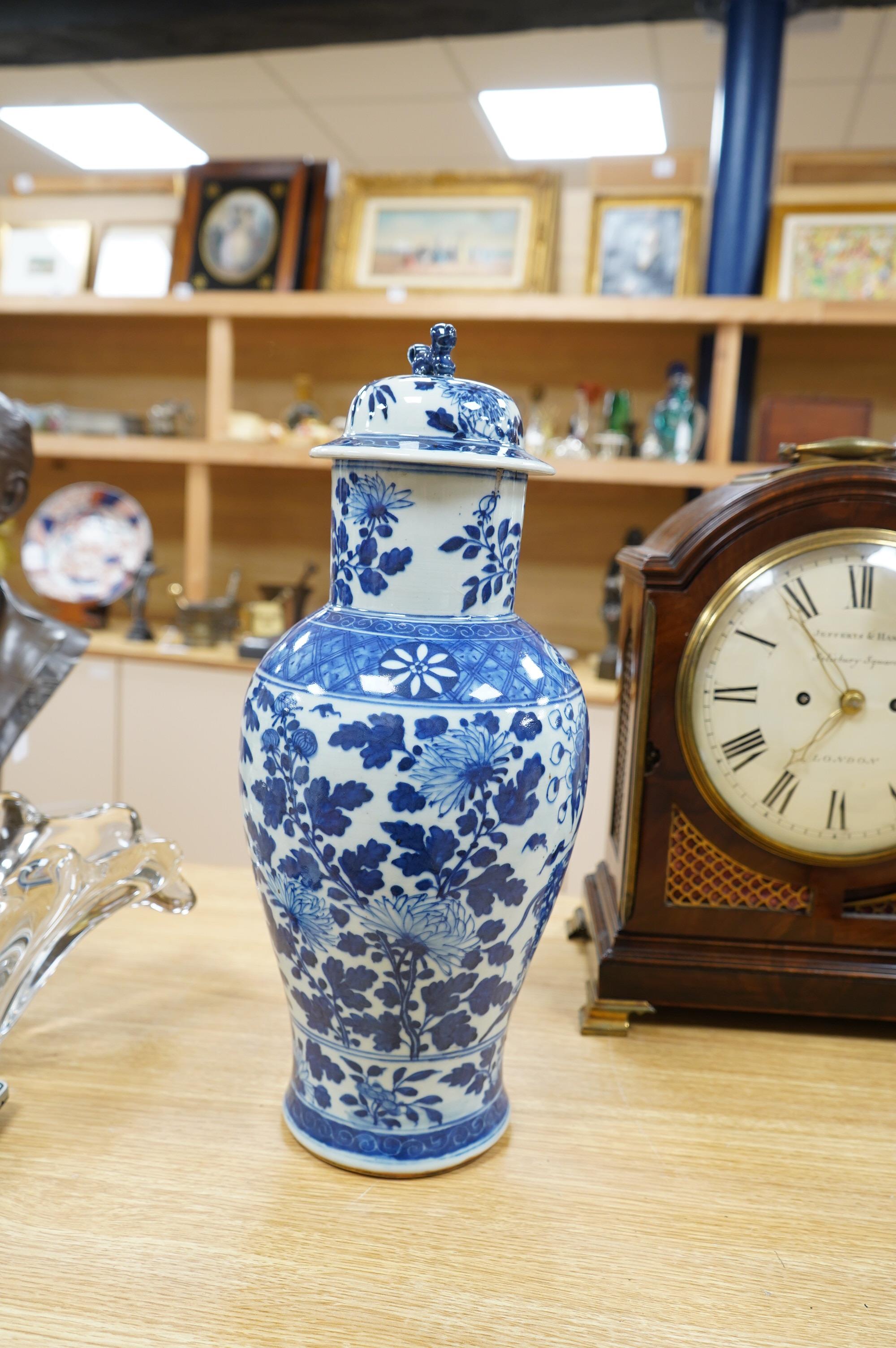 An early 20th century Chinese blue and white dragon vase and cover, 42cm high. Condition - crack and chip from rim of vase down the neck